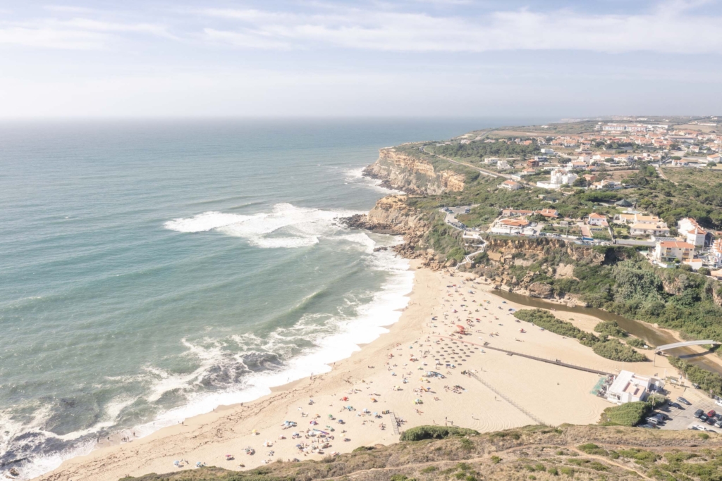 Aerial view of San Lourenço beach in summertime full of people enjoying the sun and water