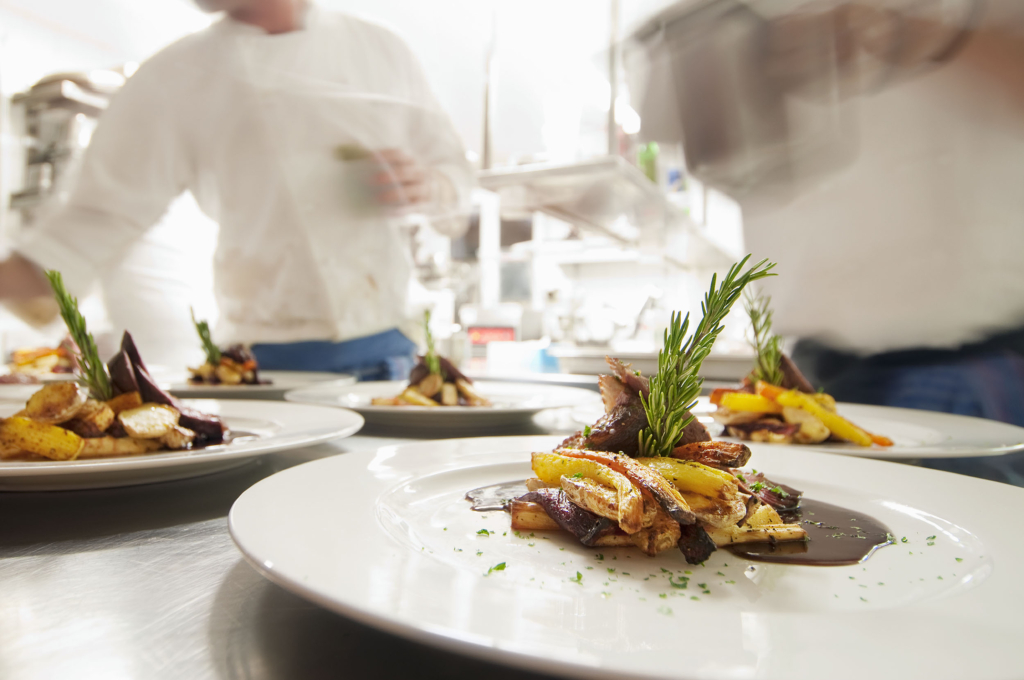 Professional chefs plating dishes that are about to be served